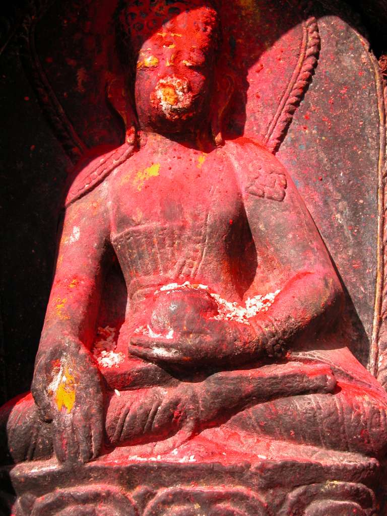 Manaslu 00 09 Kathmandu Boudhanath Statue Closeup Around the base of the Kathmandus Boudhanath Stupas circular mound are 108 niches, each containing the Dhyani Buddha Akshobhya, with a decidedly Hindu flavour. Akshobhya is blue with his right hand touching the earth while his left hand holds a begging bowl. He is the Buddha of the East and is dedicated to helping you overcome hatred, anger and aversion.